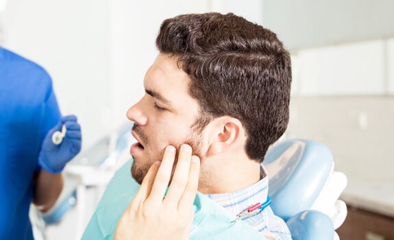 Anxious patient talking with the dentist about oral sedation